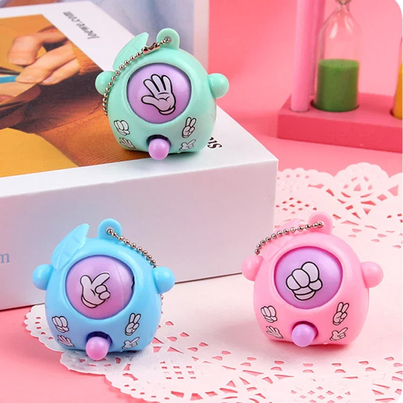 Three small, round guessing game eggs in teal, blue, and pink with handprints and flowers.