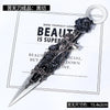A dark decorative utility knife or kunai with a silver handle and intricate detailing shown against a white background.