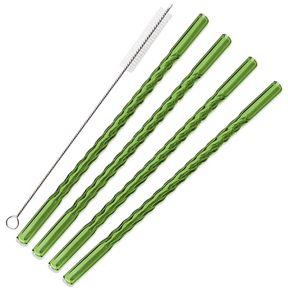 A set of green reusable borosilicate glass straws with cleaning brushes.
