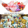 A mesh storage hammock filled with various stuffed animals and toys for organizing.