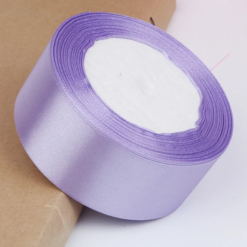 Roll of purple satin ribbon for crafts and gift wrapping