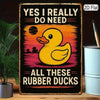 A vertical black wall sign featuring a yellow rubber duck silhouette against an orange sunset background with text reading Ye