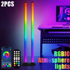 Two vertical RGB lights illuminate a desk setup with a computer monitor and keyboard.