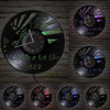 A collection of vintage vinyl record wall clocks featuring the text Life is a lot like Jazz on black backgrounds.