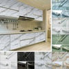 Various rolls and sheets of self-adhesive marble contact paper in white, gray, and green tones.