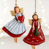 A set of four vintage wood angel ornaments with wings and Christmas tree designs hanging by twine.