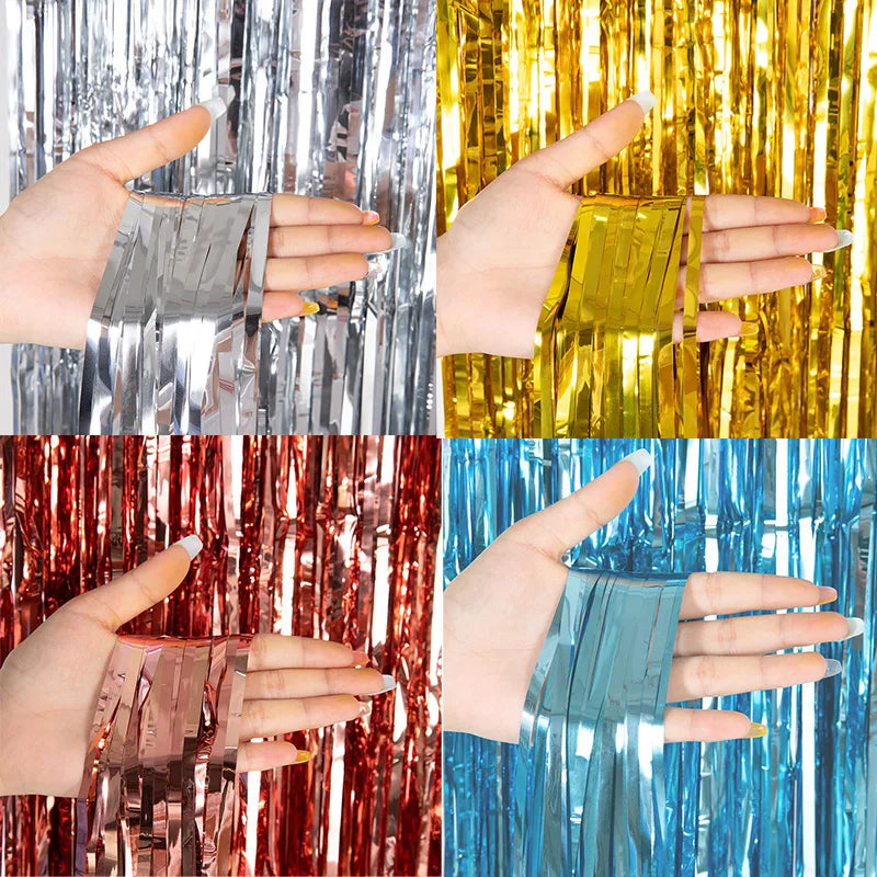 Three hands display metallic tinsel foil fringe curtains in silver, gold, and red against a backdrop.