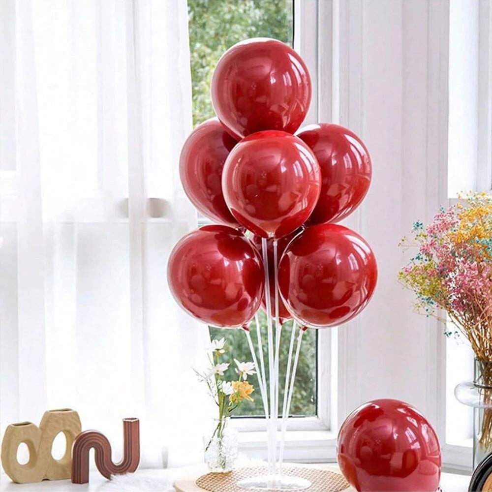 A display of red glossy balloons arranged on a stand for party decorations.