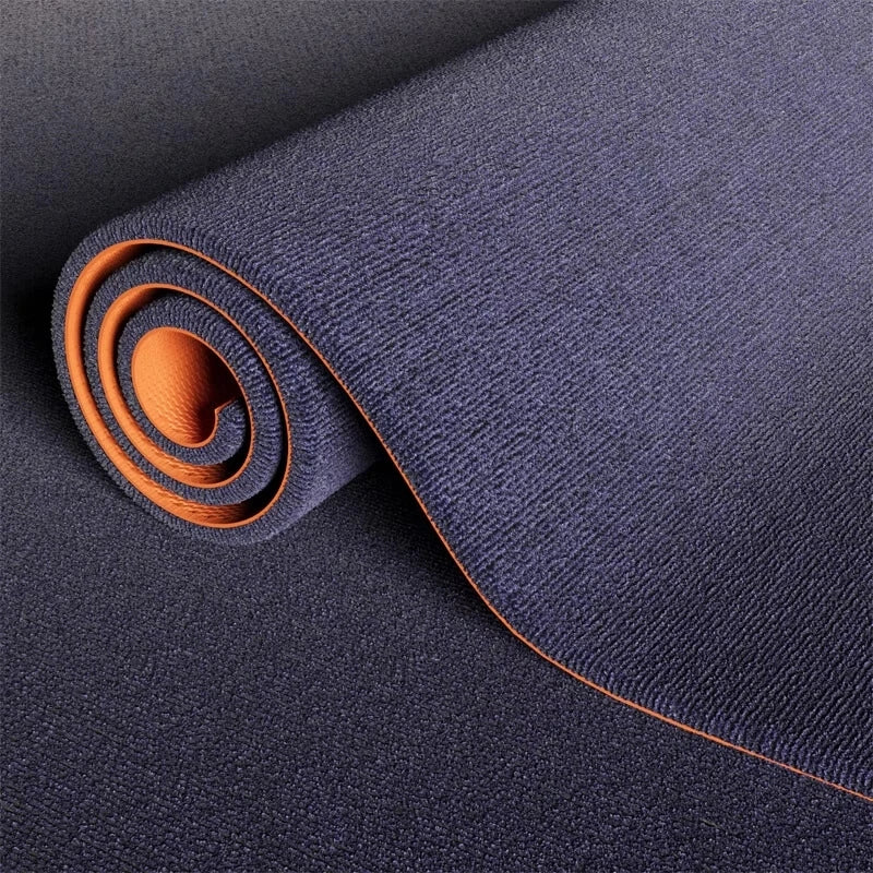 A roll of dark blue artificial grass carpet with an orange accent, shown in a close-up view.