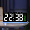 A black digital alarm clock with a bright display showing 22:38 and a mood light illuminating the surface.