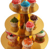 A three-tier rainbow cupcake stand displaying various colorful cupcakes on a gold pedestal.