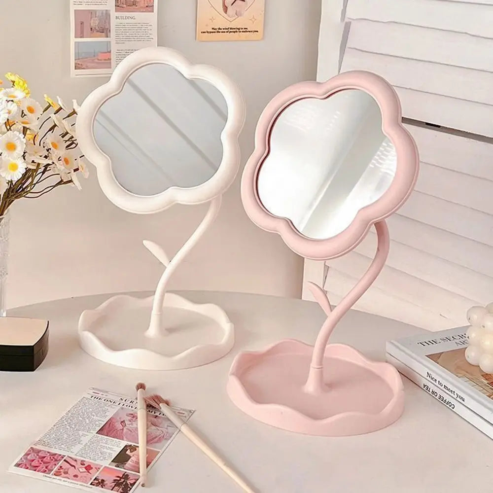 A pink sunflower heart dressing makeup mirror with a white frame and stand on a light surface.