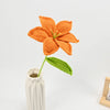 Hand-crocheted orange lily bouquet with green stem and leaf