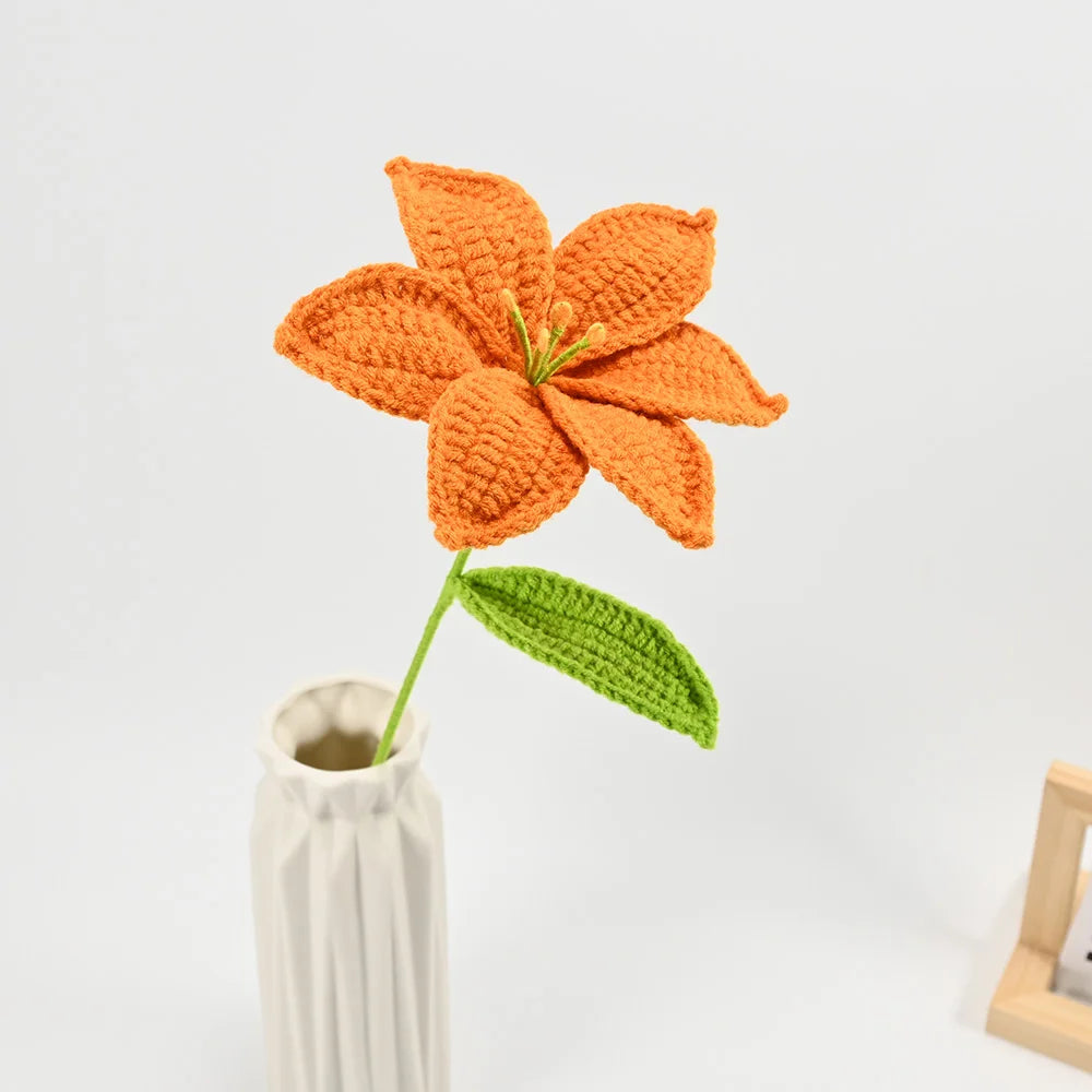 Hand-crocheted orange lily bouquet with green stem and leaf