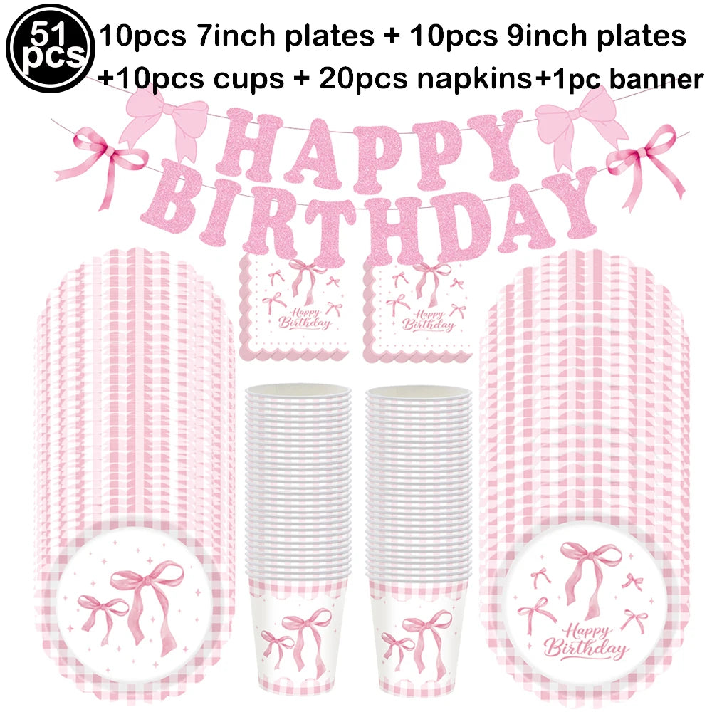 Pink bow themed birthday party supplies including plates, cups, napkins, and a banner