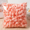 A clear plastic bag filled with pink PE foam artificial rose flowers for DIY decor
