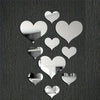 A collection of white 3D love heart mirror wall stickers arranged in various sizes on a dark textured background.