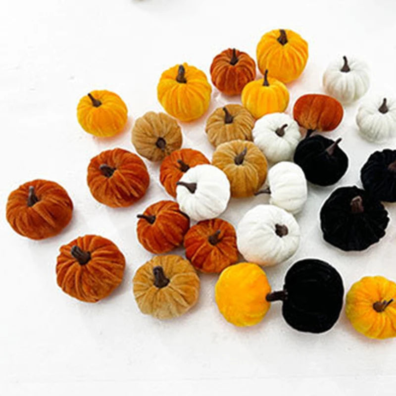 A set of five foam pumpkins in various colors including orange, yellow, white, and black for Halloween decor.