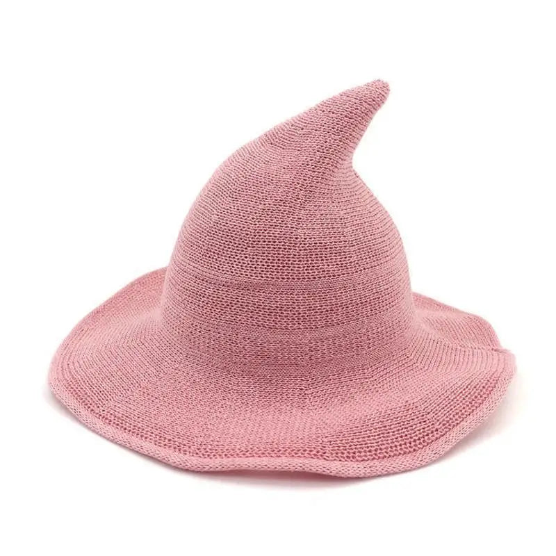 A pink vintage knit witch hat with a pointed crown and wide brim.
