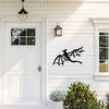 A white clapboard house exterior featuring a black dragon metal wall art panel mounted on the siding.