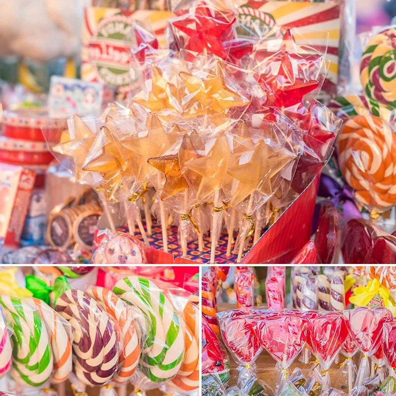 A close-up of a large quantity of colorful lollipops packaged in clear plastic with paper sticks and tie closures.