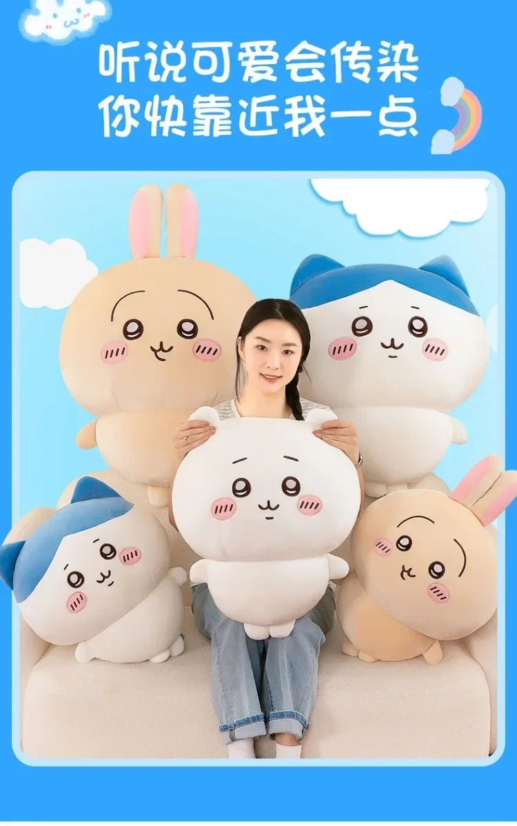 A woman is surrounded by several soft, pink and blue Chiikawa plush dolls, including a large one and smaller ones.