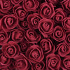 A close-up view of a bulk pack of realistic, deep red foam rose flowers.
