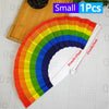 A colorful folding bamboo hand fan displaying a rainbow spectrum, shown against a white grid background.