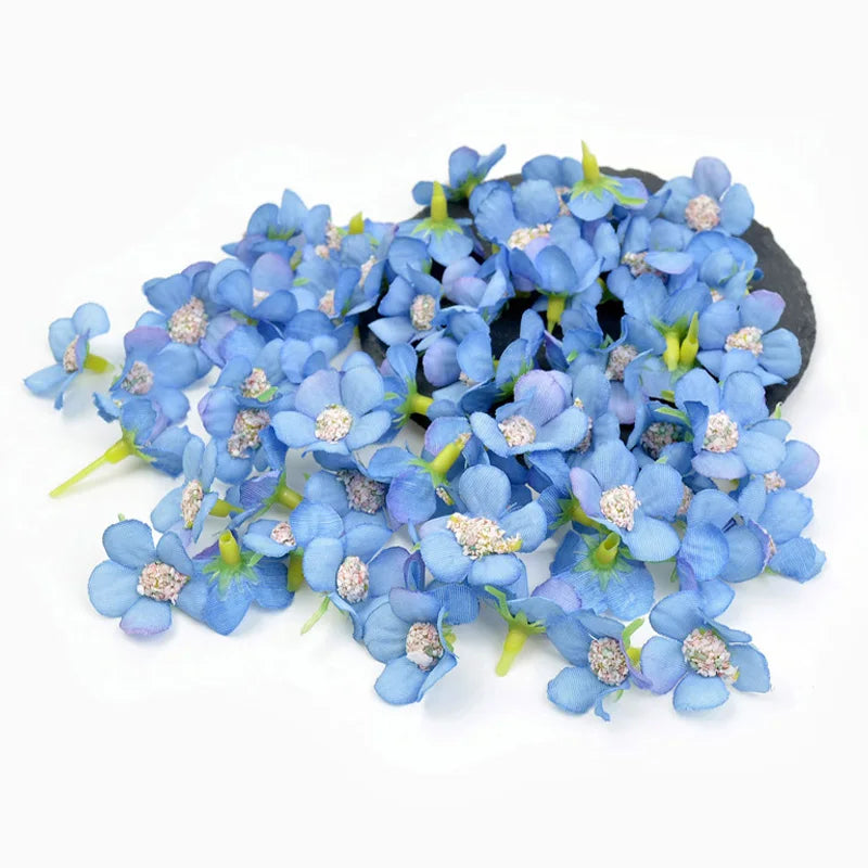 A cluster of small blue hydrangea flower heads on a dark background.