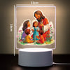 A 3D LED night light featuring a painting of Jesus with children, displayed on a white base.