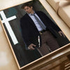 A movie poster featuring a man in a suit and tie against a dark background, framed for wall art.