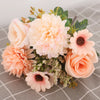 A bouquet of silk autumn roses and hydrangea flowers in soft peach and cream tones.