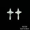 A pair of silver crucifix pendants featuring a depiction of Christ and St. Benedict with an enamel finish.