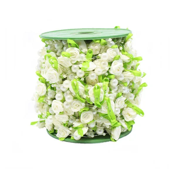 A green cylindrical container filled with white roses, pearl accents, and green leaf ribbon for floral arrangements.