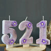 Purple sparkling number candles forming the number 521 for a birthday cake decoration