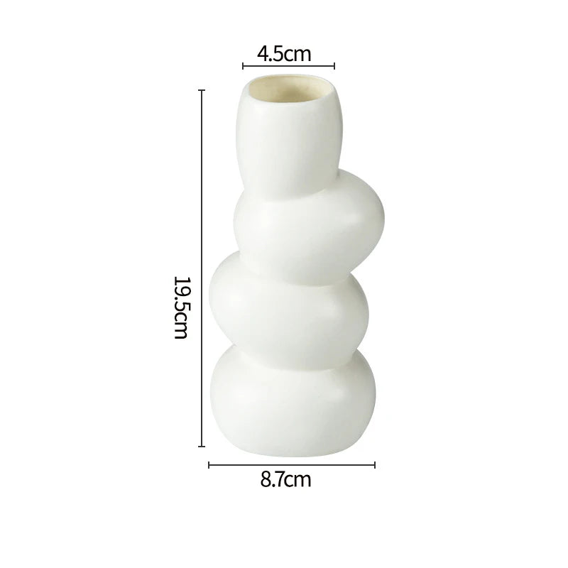 Modern white plastic decorative vase with stacked, rounded sections.