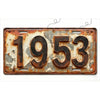 A vintage, weathered aluminum license plate tag displaying the year 1953.