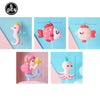 A set of five pink and white ocean animal cake toppers including a crab, turtle, octopus, whale, and starfish.