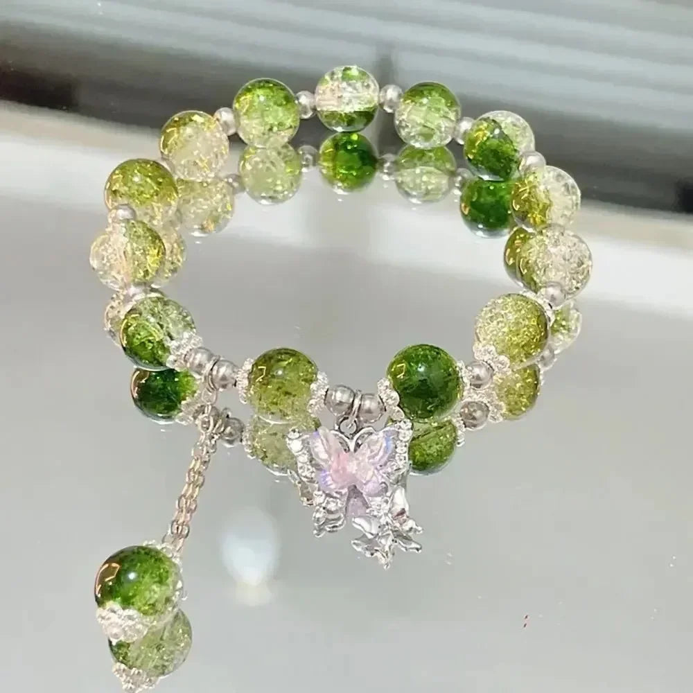 A bracelet made of small, round, translucent green and pale yellow natural stones.