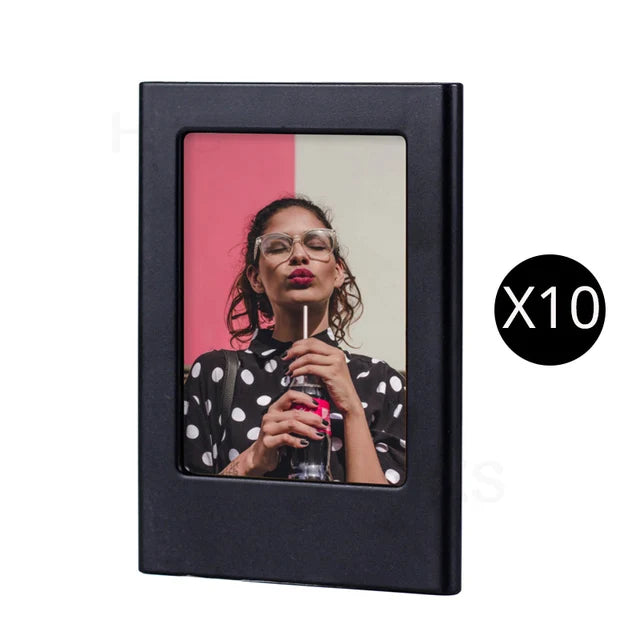 A black magnetic double-sided frame displaying a portrait of a woman with glasses and dark hair.
