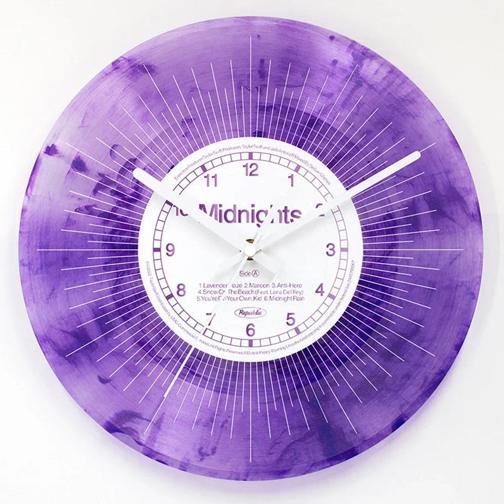 A purple watercolor vinyl record wall clock with a white face and black hands.