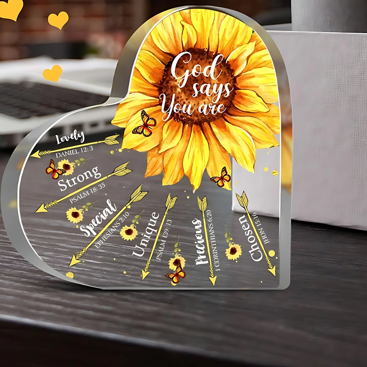 A heart-shaped plaque with a sunflower design and Bible verses like God says you are and Strong.
