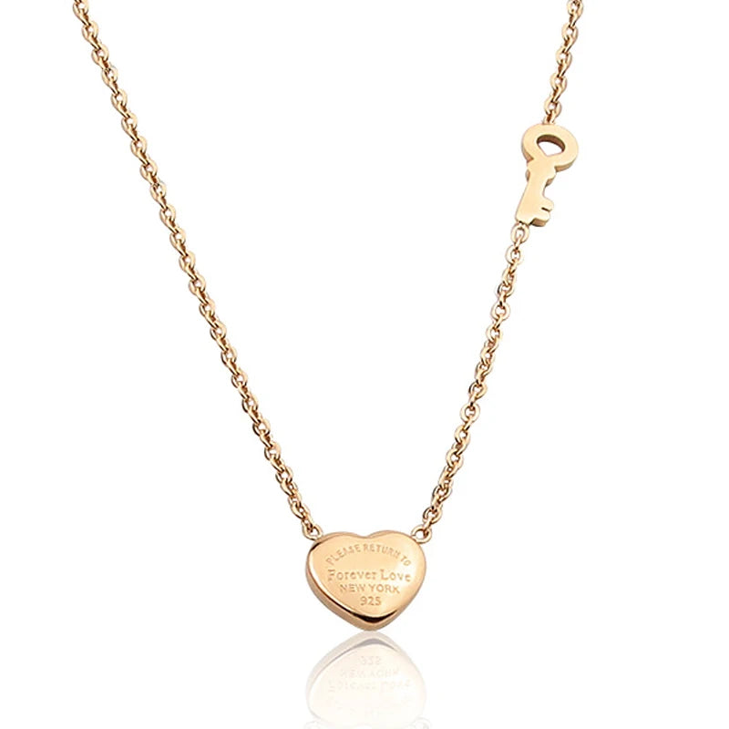 Gold-toned heart lock key pendant necklace with engraved Forever Love New York 325 on a gold chain