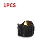 A single black flameless LED candle with a warm white glow.
