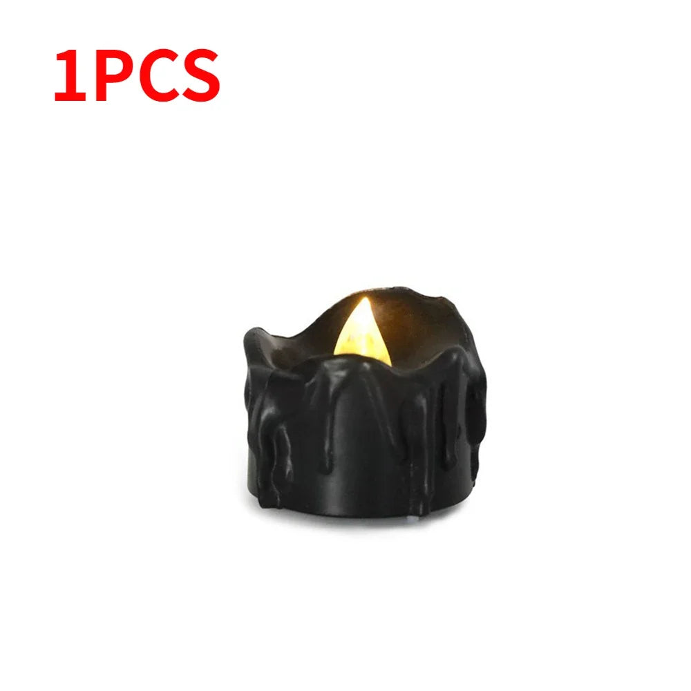 A single black flameless LED candle with a warm white glow.