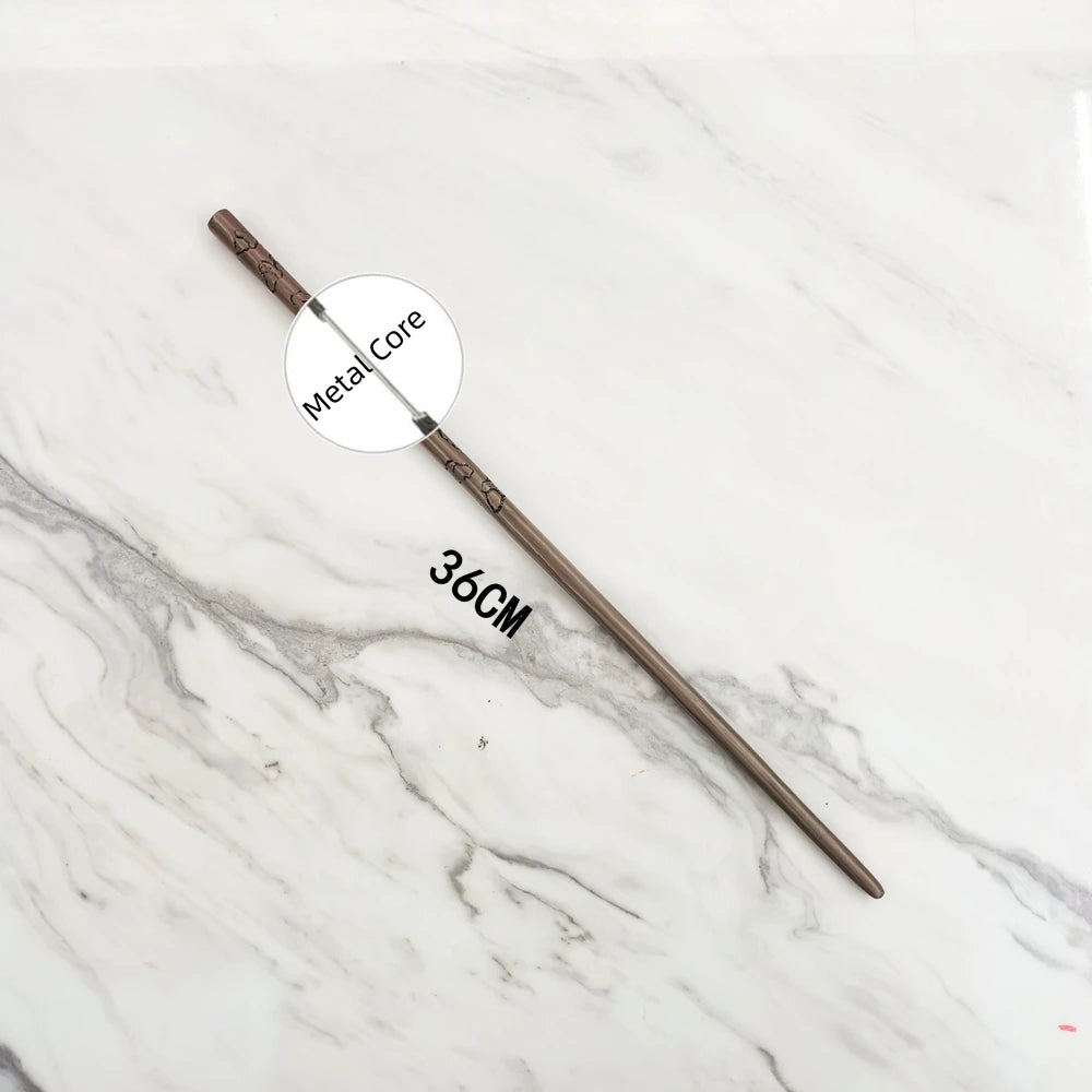 A long, thin metal wand replica with a labeled metal core is displayed on a white marble surface.