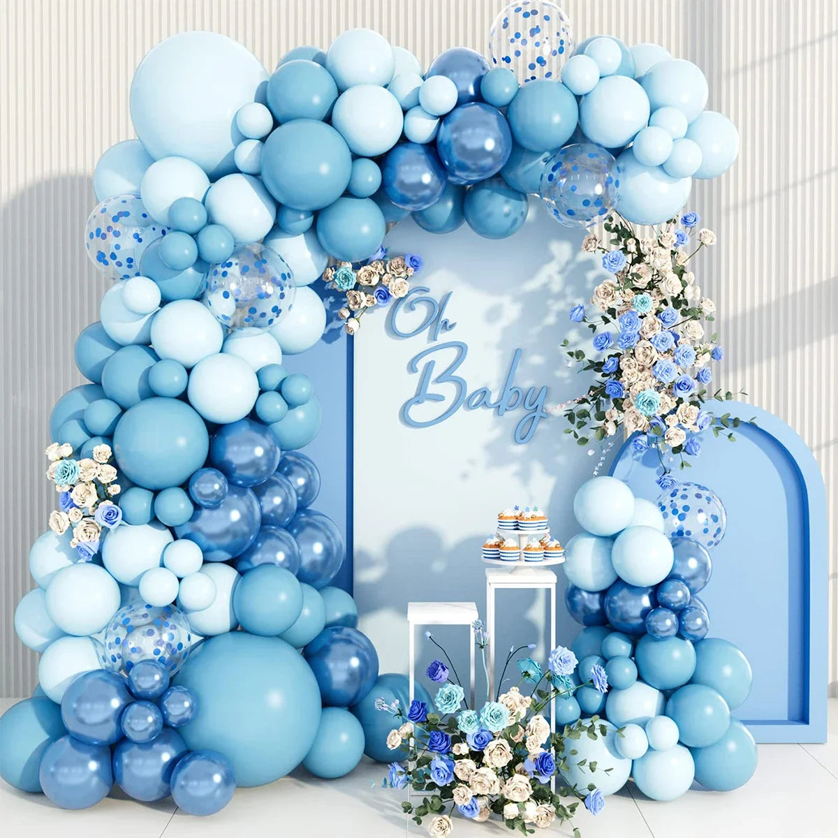 A blue balloon garland arch kit featuring light and dark blue balloons decorated with white flowers for weddings or parties.