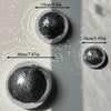 Collection de suspensions en verre miroir rond, boules disco, de différents diamètres, sur fond gris clair.