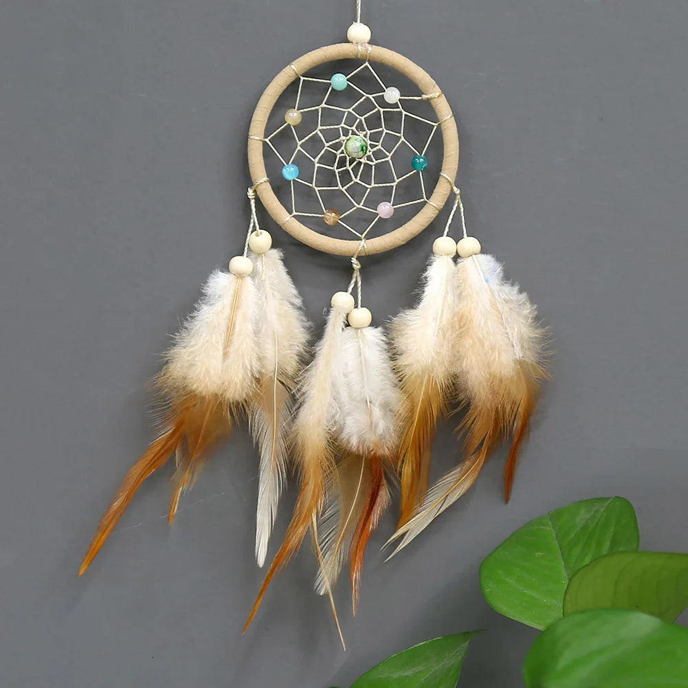 Handmade boho feather dream catcher wall decor with a circular woven hoop and hanging feathers