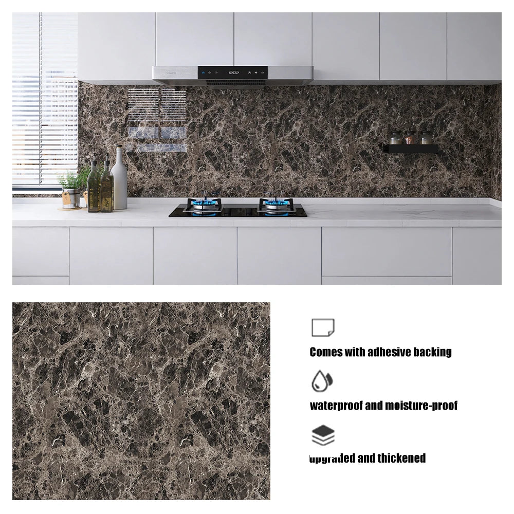 A kitchen countertop featuring a dark marbled backsplash panel with an induction cooktop and modern cabinetry.